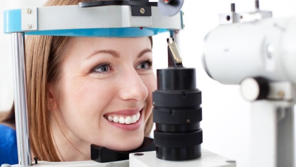 Woman undergoing comprehensive eye exam