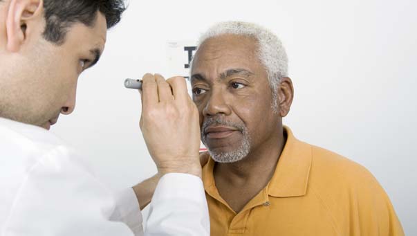 Doctor checking patient's eye.