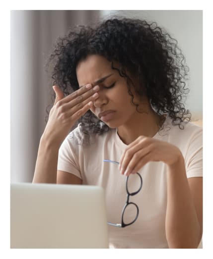 Woman showing symptoms of computer vision syndrome