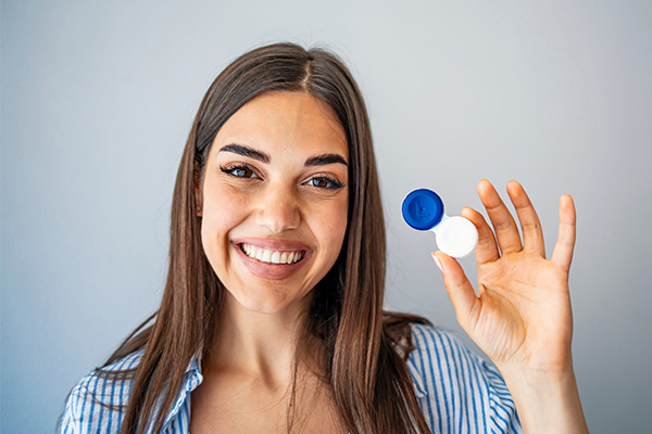 Woman holding contact lens at Big City Optical