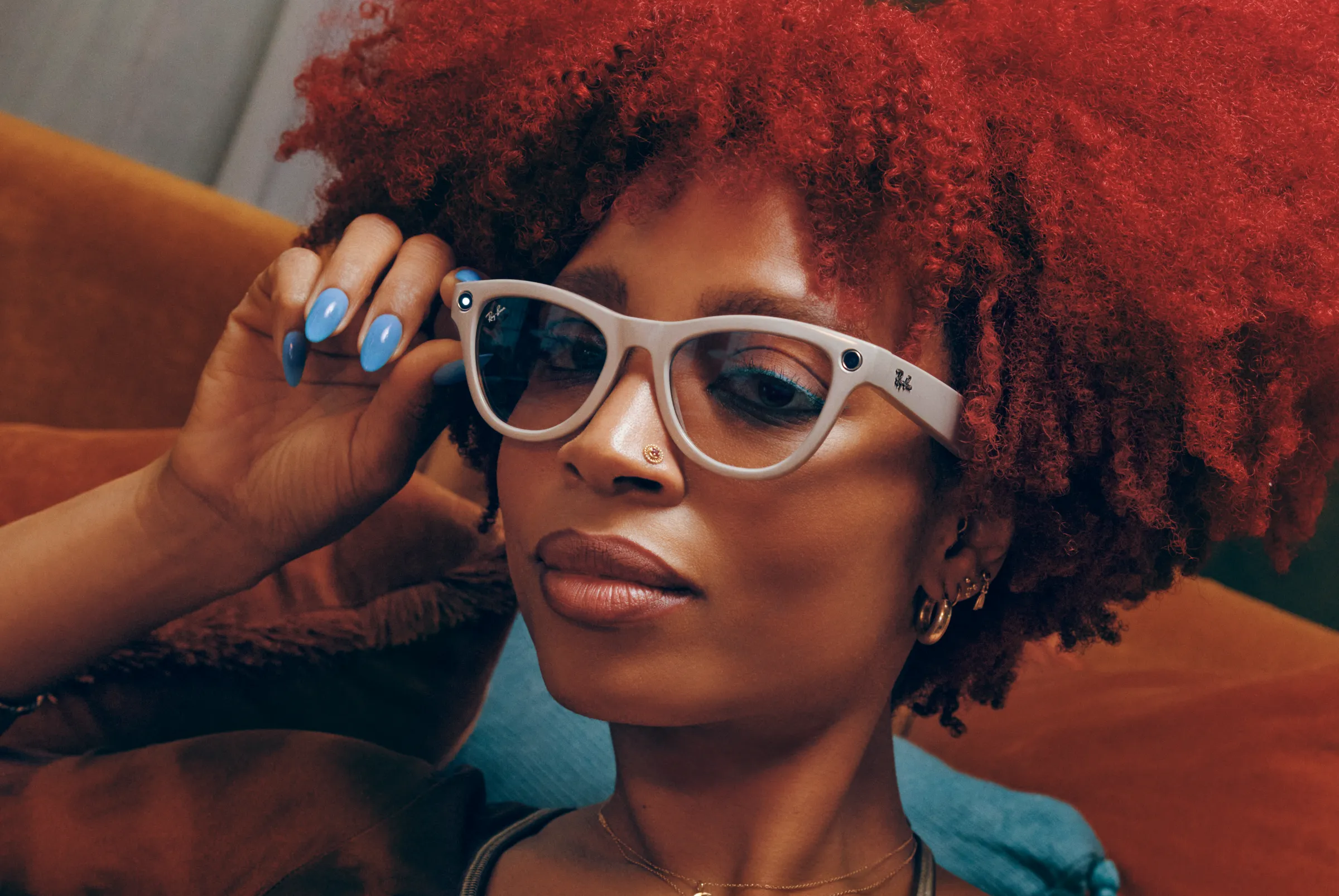 Gorgeous red hair woman wearing ray-ban glasses hand holding the glasses