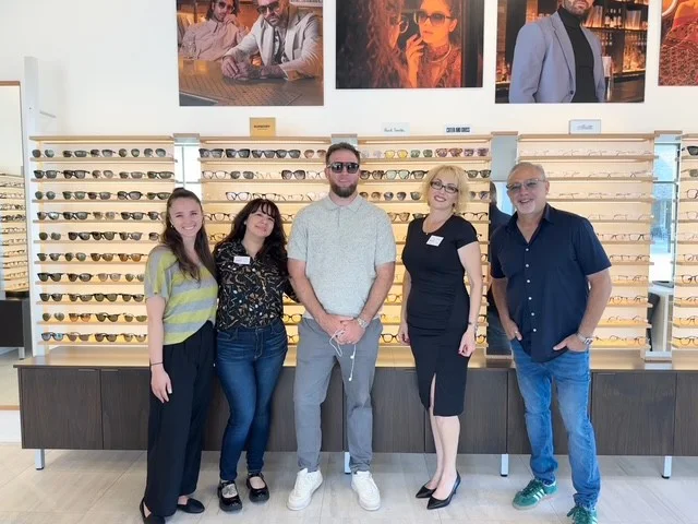 A woman selecting eyeglasses at Big City Optical.<br />
